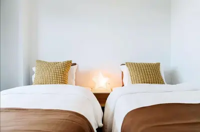 two beds sitting next to each other in a room at Nine Lane Omori in Tokyo
