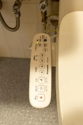a remote control for a toilet in a bathroom at Beige Frame in Tokyo