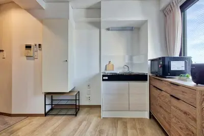 a kitchen with a sink and a microwave at CraftFlat Komagome 508, a compact studio at excellent location in Tokyo