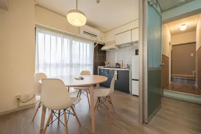 a kitchen and dining room with a table and chairs at 15 min Ikebukuro Tokyo 2-BR Apartment in Tokyo