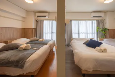 a bedroom with two beds with towels on them at 15 min Ikebukuro Tokyo 2-BR Apartment in Tokyo