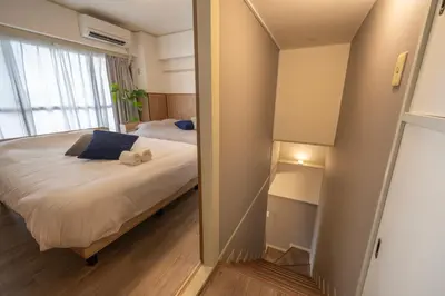 a small bedroom with a bed and a mirror at 15 min Ikebukuro Tokyo 2-BR Apartment in Tokyo