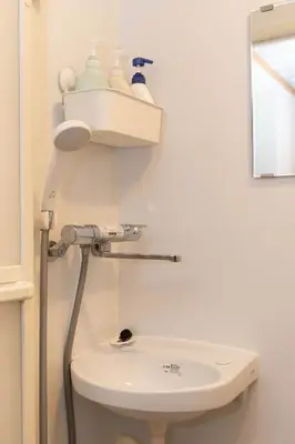 a bathroom with a toilet and a sink at Villa Ōyama in Tokyo