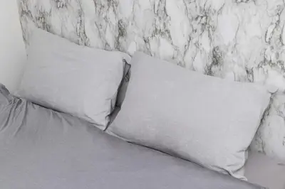 two white pillows sitting on a bed with a wall at Villa Ōyama in Tokyo