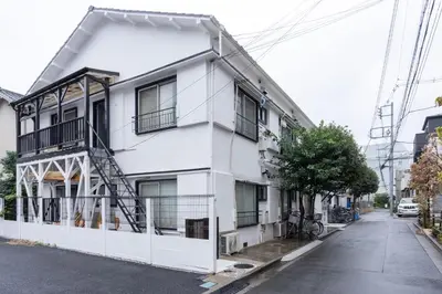a white building on a street at Villa Ōyama in Tokyo