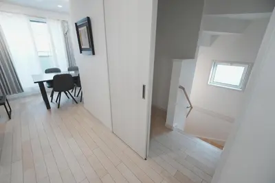 a white room with a table and chairs and a window at Dorothy Inn Spacious 4LDK New Build 97sqm Up to 10 Guests Free Private Parking Near JR Higashi Jujo Station 3 Minute Walk in Tokyo