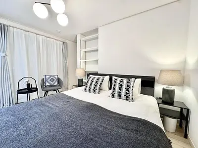 a bedroom with a large bed and a chair at Dorothy Inn Spacious 4LDK New Build 97sqm Up to 10 Guests Free Private Parking Near JR Higashi Jujo Station 3 Minute Walk in Tokyo