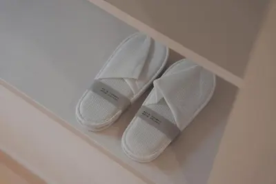 three pairs of white shoes sitting on a shelf at Dorothy Inn Spacious 4LDK New Build 97sqm Up to 10 Guests Free Private Parking Near JR Higashi Jujo Station 3 Minute Walk in Tokyo