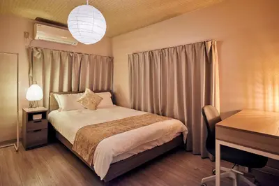 a hotel room with a bed and a desk and a desk at Hagi in Tokyo