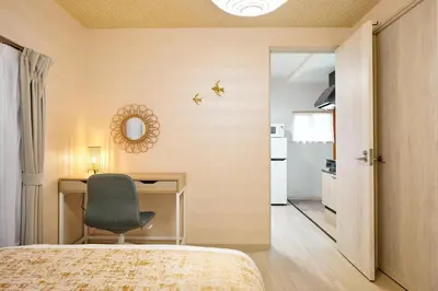 a bedroom with a desk and a chair next to a door at Hagi in Tokyo