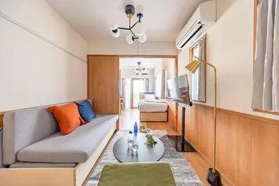 a living room with a couch and a tv at \u30e2\u30f3 \u30b7\u30e3\u30c8\u30fc\u4e2d\u91ce\u5e73\u548c\u306e\u68ee in Tokyo