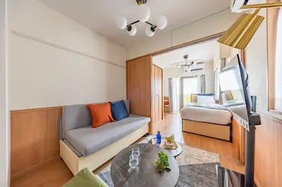 a small living room with a couch and a bed at \u30e2\u30f3 \u30b7\u30e3\u30c8\u30fc\u4e2d\u91ce\u5e73\u548c\u306e\u68ee in Tokyo