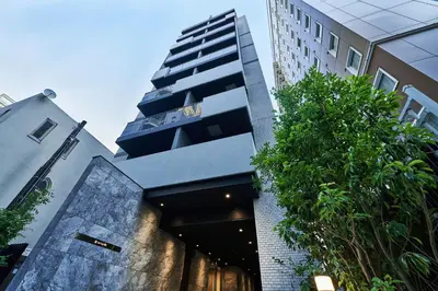 a tall building with a staircase in front of it at LIVECASA\u8535\u524d 2mins to Kuramae station in Tokyo