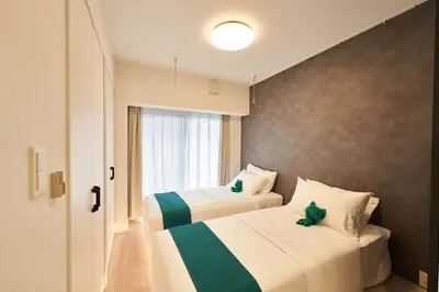 a hotel room with two beds and a window at LIVECASA\u8535\u524d 2mins to Kuramae station in Tokyo