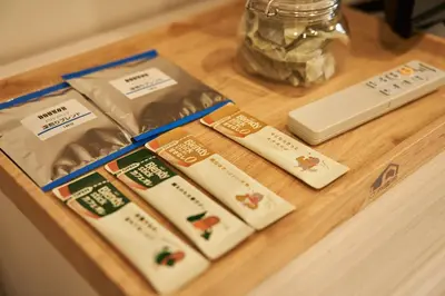 two packages of food sitting on a wooden table at LIVECASA\u8535\u524d 2mins to Kuramae station in Tokyo