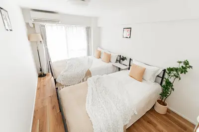 a bedroom with two beds and a window at Shinjuku Center Apart ment in Tokyo