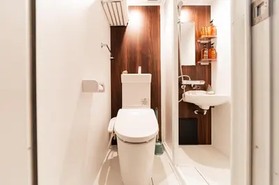 a bathroom with a toilet and a sink at Shinjuku Center Apart ment in Tokyo