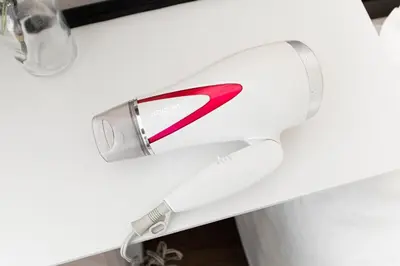 a white trash can with a red handle at Shinjuku Center Apart ment in Tokyo