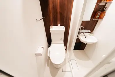 a bathroom with a toilet and a sink at Shinjuku Center Apart ment in Tokyo