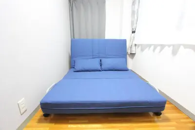 a blue bed in a room with a window at HOTEL LUANA in IKEBUKURO HIGASHINAGASAKI in Tokyo