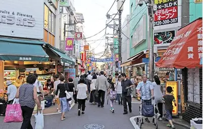 a crowd of people walking down a busy city street at HOTEL LUANA in IKEBUKURO HIGASHINAGASAKI in Tokyo