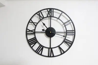 a large black and white clock on a wall at HOTEL LUANA in IKEBUKURO HIGASHINAGASAKI in Tokyo