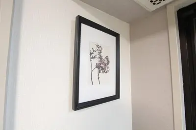 a framed picture of flowers on a wall at HOTEL LUANA in IKEBUKURO HIGASHINAGASAKI in Tokyo