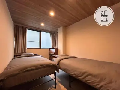 a bedroom with two beds and a window at 磐-Comfortable Home with 2BR-Sleeps 6 in Kagurazaka Near Yayoi Kusama Museum , Tokyo Dome , Sakura Lovers' Choice-Kanda River in Tokyo