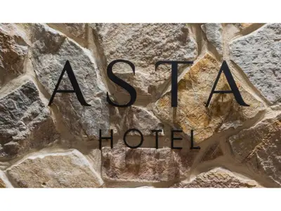 a sign for a hotel on a stone wall at ASTA HOTEL - Vacation STAY 87171v in Tokyo