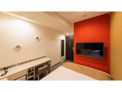 a room with a red wall with a flat screen tv at ASTA HOTEL - Vacation STAY 87206v in Tokyo