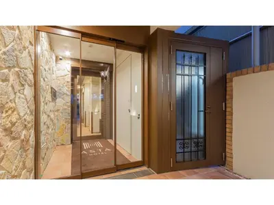 a building with glass doors and a stone wall at ASTA HOTEL - Vacation STAY 87206v in Tokyo