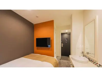 a bedroom with a bed and a bathroom with a tv at ASTA HOTEL - Vacation STAY 87210v in Tokyo
