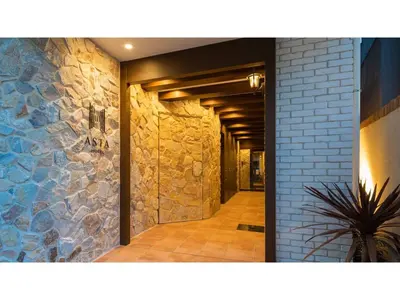 a hallway of a building with a stone wall at ASTA HOTEL - Vacation STAY 87220v in Tokyo