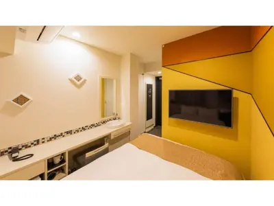 a room with a bed and a tv on a wall at ASTA HOTEL - Vacation STAY 87298v in Tokyo