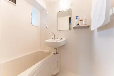 a white bathroom with a sink and a bath tub at Ohana's room Walk to Shibuya station by 8 minutes private apartment studio Max6 in Tokyo