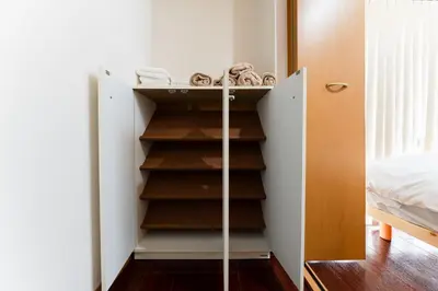 a closet with wooden shelves in a bedroom at Ohana's room Walk to Shibuya station by 8 minutes private apartment studio Max6 in Tokyo