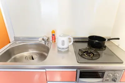 a kitchen counter with a sink and a pot on a stove at Ohana's room Walk to Shibuya station by 8 minutes private apartment studio Max6 in Tokyo
