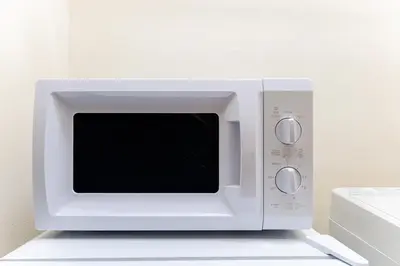 a white microwave oven sitting on top of a counter at Ohana's room Walk to Shibuya station by 8 minutes private apartment studio Max6 in Tokyo