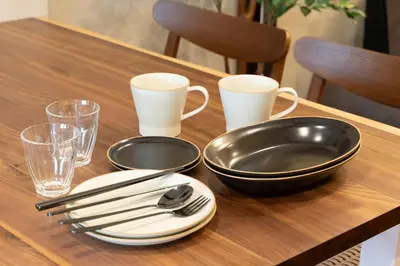 a wooden table with plates and utensils on it at \u548c\u6c17\u4f1a\u3005\u690e\u540d\u753a Wakiaiai Shiinamachi in Tokyo