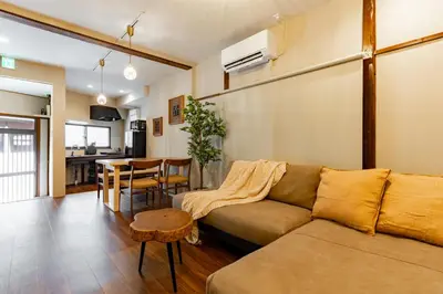 a living room with a couch and a table at \u548c\u6c17\u4f1a\u3005\u690e\u540d\u753a Wakiaiai Shiinamachi in Tokyo