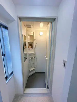 a hallway with a refrigerator in a room at \u6696\u71c8 DANTO inn 2F in Tokyo