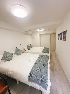 a bedroom with two beds in a room at \u6696\u71c8 DANTO inn 2F in Tokyo