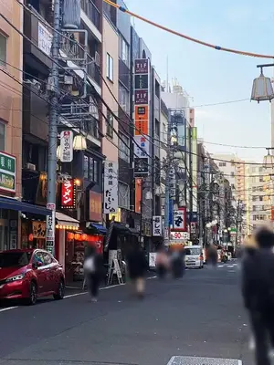 a busy city street with buildings and cars on the road at \u6696\u71c8 DANTO inn 2F in Tokyo
