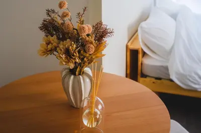 a vase with flowers sitting on a table at Comfy Stay Tokiwadai 2minute walk from Tokiwadai Station Ikebukuro 9min Shinjuku 14min Shibuya 18min Max 4guests Many restaurants nearby hot spring Shrine nearby in Tokyo