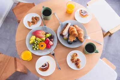 a table with plates of breakfast foods and cups of coffee at Comfy Stay Tokiwadai 2minute walk from Tokiwadai Station Ikebukuro 9min Shinjuku 14min Shibuya 18min Max 4guests Many restaurants nearby hot spring Shrine nearby in Tokyo