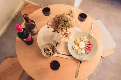 a table with a plate of food and two bottles of wine at Comfy Stay Tokiwadai 2minute walk from Tokiwadai Station Ikebukuro 9min Shinjuku 14min Shibuya 18min Max 4guests Many restaurants nearby hot spring Shrine nearby in Tokyo