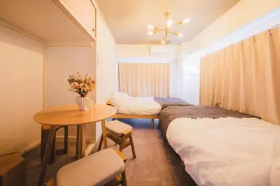 a room with two beds and a table and a table and chairs at Comfy Stay Tokiwadai 2minute walk from Tokiwadai Station Ikebukuro 9min Shinjuku 14min Shibuya 18min Max 4guests Many restaurants nearby hot spring Shrine nearby in Tokyo