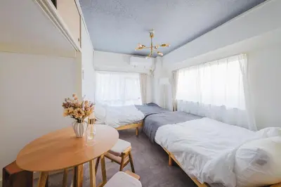 a room with two beds and a table with a table sidx sidx at Comfy Stay Tokiwadai 2minute walk from Tokiwadai Station Ikebukuro 9min Shinjuku 14min Shibuya 18min Max 4guests Many restaurants nearby hot spring Shrine nearby in Tokyo