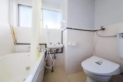 a white bathroom with a toilet and a sink at Comfy Stay Tokiwadai 2minute walk from Tokiwadai Station Ikebukuro 9min Shinjuku 14min Shibuya 18min Max 4guests Many restaurants nearby hot spring Shrine nearby in Tokyo