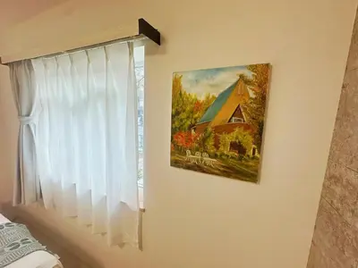 a painting of a barn on a wall next to a window at \u6696\u71c8 DANTO inn 1F in Tokyo